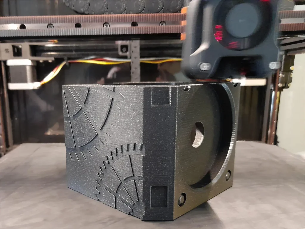 Custom 3D-printed puzzle box housing with intricate gear details, modeled and produced by OrangeCube3D in galaxy PETG filament
